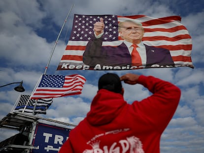 Un partidario de Trump saludaba el lunes a una bandera con su foto cerca del domicilio del magnate en Mar-a-Lago (Florida).