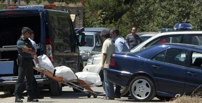 Empleados del servicio judicial en presencia de la Guardia Civil retiran el cuerpo de la joven apu&ntilde;alada en el Camino del Olivar de Chipiona (C&aacute;diz).