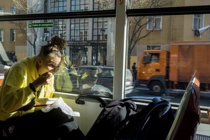 Una chica come durante su trayecto en autobús. Tan solo el 7% de los madrileños asegura que no utiliza nunca el transporte público, según la encuesta Hábitos y actitudes del transporte en el Área Metropolitana de Madrid.