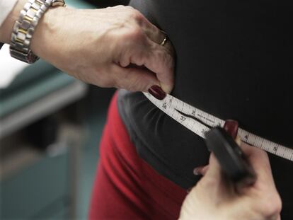 A waist is measured during an obesity prevention study in Chicago, Jan. 20, 2010