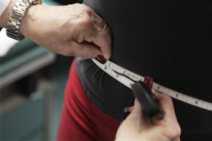 A waist is measured during an obesity prevention study in Chicago, Jan. 20, 2010.
