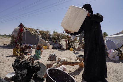 Una mujer vierte las últimas gotas de agua de una botella para preparar la comida junto a su tienda de campaña en el campo de Al-Khuseif para desplazados internos en Marib, Yemen. La familia trae agua potable en botellas de lejos porque no hay en la zona. Pincha en la imagen para ver la fotogalería completa.