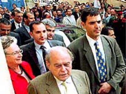 Jordi Pujol, seguido de su esposa y protegido por guardaespaldas, a su llegada al consejo comarcal.