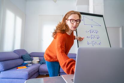 Teacher woman teaching remotely from home Maths class