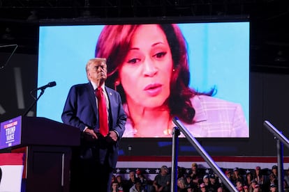 Donald Trump, in front of an image of his Democratic rival, Kamala Harris, at a rally in Detroit.