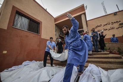 Civiles y personal sanitario trasladan uno de los cadáveres de la morgue del hospital Nasser, en Jan Yunis, para su funeral en la franja de Gaza, este lunes.