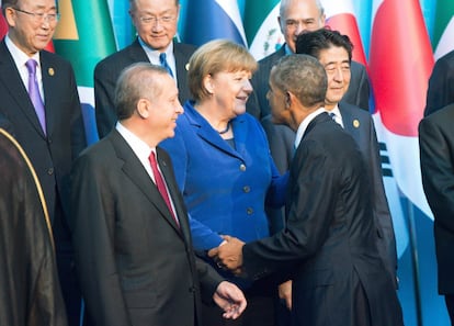 El presidente de Estados Unidos, Barack Obama, saluda a la canciller alemana, Angela Merkel, antes de la foto de familia.
