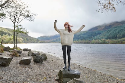 Woman laughing by the side of a loch