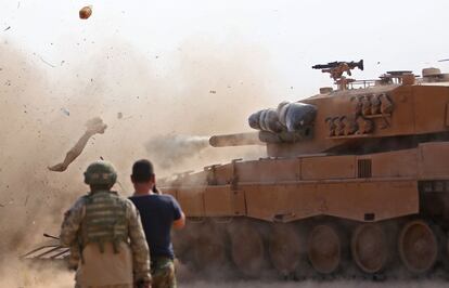Soldados turcos al este de la ciudad siria nororiental de Ras al-AIn observan un tanque dirigido por combatientes del Ejército Democrático Sirio (SDF).