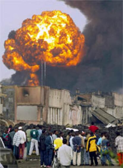 Varios habitantes de Goma observan la bola de fuego en la que se ha convertido la gasolinera.