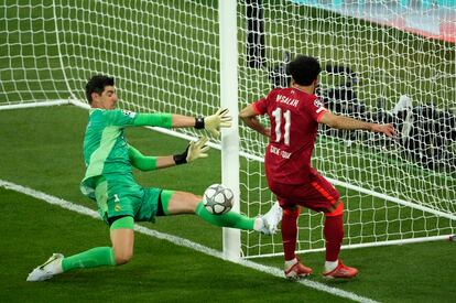 Thibaut Courtois, left, makes a save in front of Liverpool's Mohamed Salah