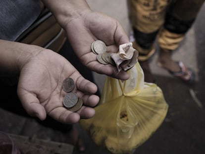 Una persona sostiene pesos colombianos en un mercado de alimentos en Riohacha (Colombia).