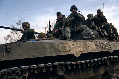 Ukrainian soldiers ride atop an APC on the frontline in Bakhmut, Donetsk region, Ukraine, on March 22, 2023.