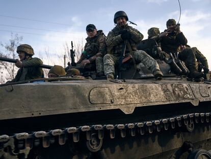 Ukrainian soldiers ride atop an APC on the frontline in Bakhmut, Donetsk region, Ukraine, on March 22, 2023.