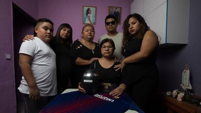 The family of Carlos Alberto Perry Carbajal stand with his ashes.
