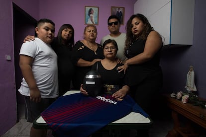 The family of Carlos Alberto Perry Carbajal stand with his ashes.