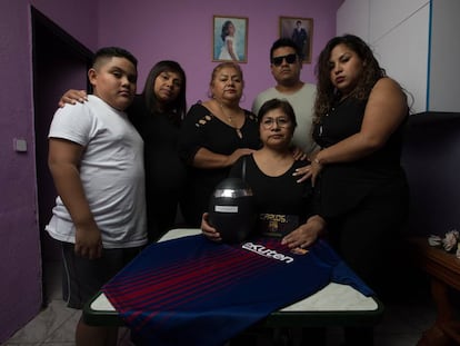 The family of Carlos Alberto Perry Carbajal stand with his ashes.