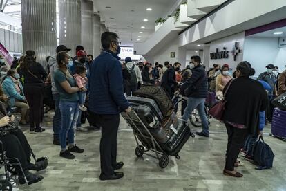 Trabajadores del aeropuerto piden a los pasajeros evitar las aglomeraciones.