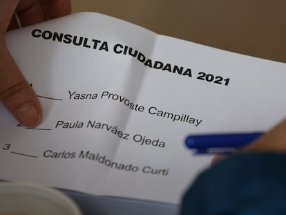 Una persona sostiene una papeleta de la consulta ciudadana presidencial del pacto Unidad Constituyente, este sábado en Santiago de Chile.