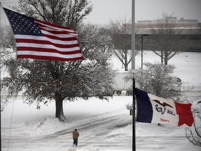 A person walks in snow and high winds as a winter storm moves through the midwest United States in Des Moines, Iowa, U.S., January 9, 2024.