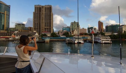 Una pasajera del ferri entre Dar es Salaam y Zanzíbar toma una fotografía con su móvil desde la cubierta.