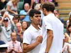 Russia's Daniil Medvedev (R) shakes hands with Spain's Carlos Alcaraz after winning their men's singles second round match on the fourth day of the 2021 Wimbledon Championships at The All England Tennis Club in Wimbledon, southwest London, on July 1, 2021. (Photo by Ben STANSALL / AFP) / RESTRICTED TO EDITORIAL USE