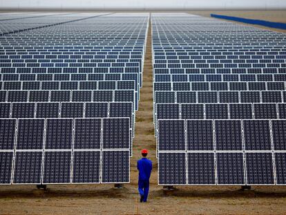 Un trabajador supervisa una instalación solar en Dunhuang (China).