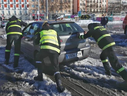 Militares de la UME ayudan a un coche a salir de la nieve en la Estación Puerta de Atocha, en Madrid (España), a 11 de enero de 2020. 