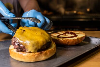 Cuando el queso está totalmente fundido, se coloca la hamburguesa encima del pan brioche. 