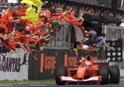 Michael Schumacher es felicitado por los miembros de su equipo tras llegar vencedor en Melbourne.