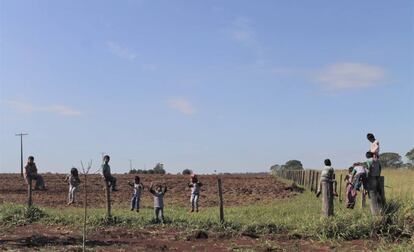 Estudantes da escola indígena da aldeia Guyraroká brincam na cerca com a fazenda vizinha da comunidade.