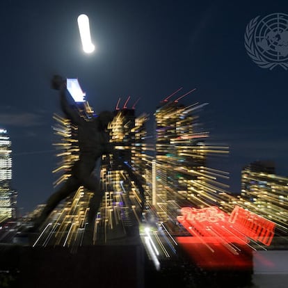 A view of the Long Island City Skyline and a full moon behind the sculpture "Good Defeats Evil", by Zurab Tsereteli, at UN Headquarters in the evening before the first day of the general debate of the General Assembly's seventy-sixth session.