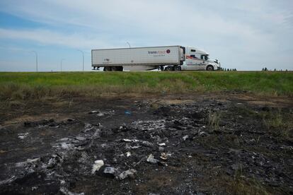 A patch of ground sits scorched where a bus carrying seniors to a casino ended up after colliding with a semi-trailer truck and burning.