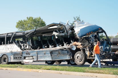 A worker helps clear the wreckage of a Greyhound bus