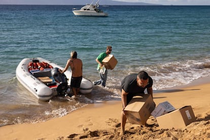 Mercy Worldwide volunteers unload supplies to West Maui towns affected by wildfires destroyed homes and businesses at Black Rock Beach in Lahaina, western Maui, Hawaii on August 12, 2023. 