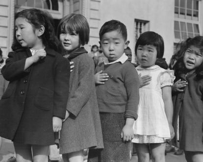 In this photo provided by the National Archives, first grade students pledge allegiance to the flag at Raphael Weill Public School at Geary and Buchanan Streets in San Francisco on April 20, 1942. Many children of Japanese ancestry attended the school, but were relocated to an internment camp for Japanese Americans.