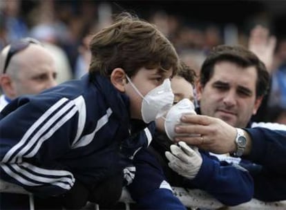 Varios niños con mascarillas asisten a un partido de fútbol en Buenos Aires.
