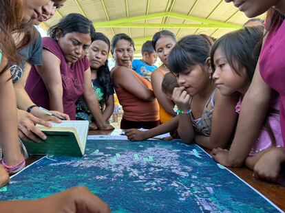 Mujeres y niñas de distintas comunidades de la región agraria de Acapulco observan un mapa del río Papagayo, que se desbordó durante el paso del huracán Otis. 