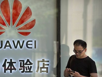 Un hombre frente a una tienda de Huawei.