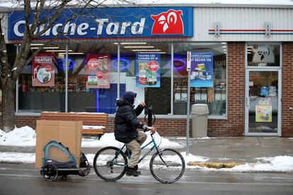 Un ciclista pasa ante una tienda Couche-Tard en Montreal (Canadá).