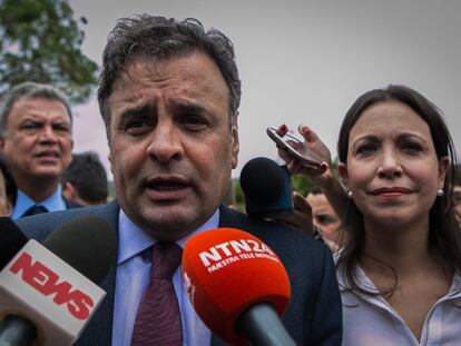 Brazilian Senator Aécio Neves and Venezuelan opposition leader María Corina Machado speak to reporters in Caracas on Thursday.