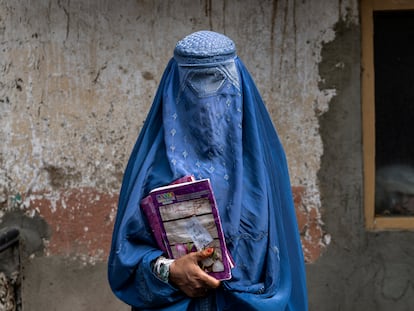 Arefeh 40-year-old, an Afghan woman leaves an underground school, in Kabul, Afghanistan, Saturday, July 30, 2022. She attends this underground school with her daughter who is not allowed to go to public school. For most teenage girls in Afghanistan, it’s been a year since they set foot in a classroom. With no sign the ruling Taliban will allow them back to school, some girls and parents are trying to find ways to keep education from stalling for a generation of young women. (AP Photo/Ebrahim Noroozi)