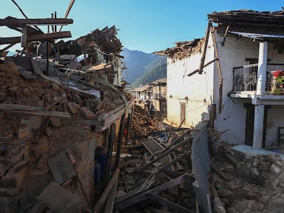 Residents walk amid the rubble of damaged homes in Jajarkot district on November 4, 2023, following an overnight a 5.6-magnitude earthquake.