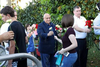 Polic&iacute;as entregan flores a los alumnos que regresan al instituto escenario de la matanza de Parkland.