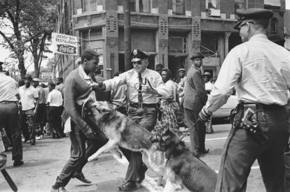 FILE- African American high school student Walter Gadsden, 15, an onlooker to the protest, is attacked by a police dog during a civil rights demonstration in Birmingham, Ala., on May 3, 1963. For some, the scene of a trucker being attacked by a police dog on a rural Ohio highway in July 2023, harkens back to the Civil Rights Movement, when authorities often turned dogs on peaceful Black protesters marching for equality.  (AP Photo/Bill Hudson, File)