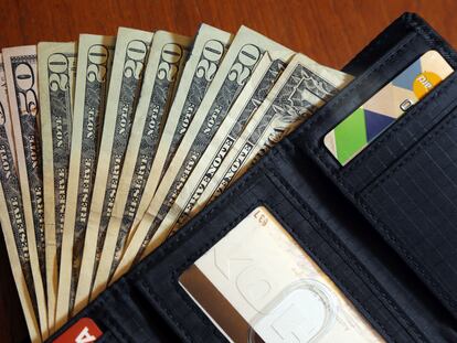 Cash is fanned out from a wallet