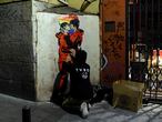 Street artist TVBoy pastes a new artwork entitled "Tokyo Loves Nairobi" depicting a rainbow-coloured heart along with two characters from the "Casa de Papel" show locked in a kiss in a street in Madrid late on September 12, 2020. (Photo by OSCAR DEL POZO / AFP) / RESTRICTED TO EDITORIAL USE - MANDATORY MENTION OF THE ARTIST UPON PUBLICATION - TO ILLUSTRATE THE EVENT AS SPECIFIED IN THE CAPTION