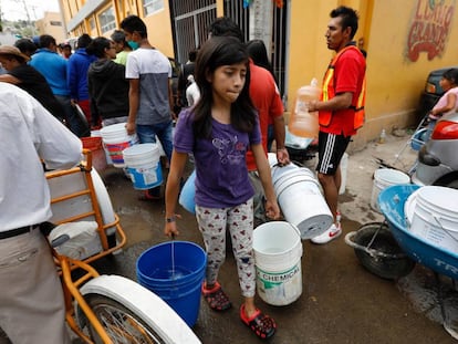 Una niña carga agua para su casa en Ciudad de México. 
