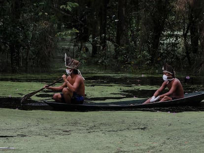 Indígenas con mascarillas navegan el río Ariau, a 80 kilómetros de Manaos, en el Estado brasileño de Amazonas.