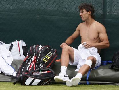 Rafael Nadal changes his shirt during a training session at Wimbledon in London on Saturday.